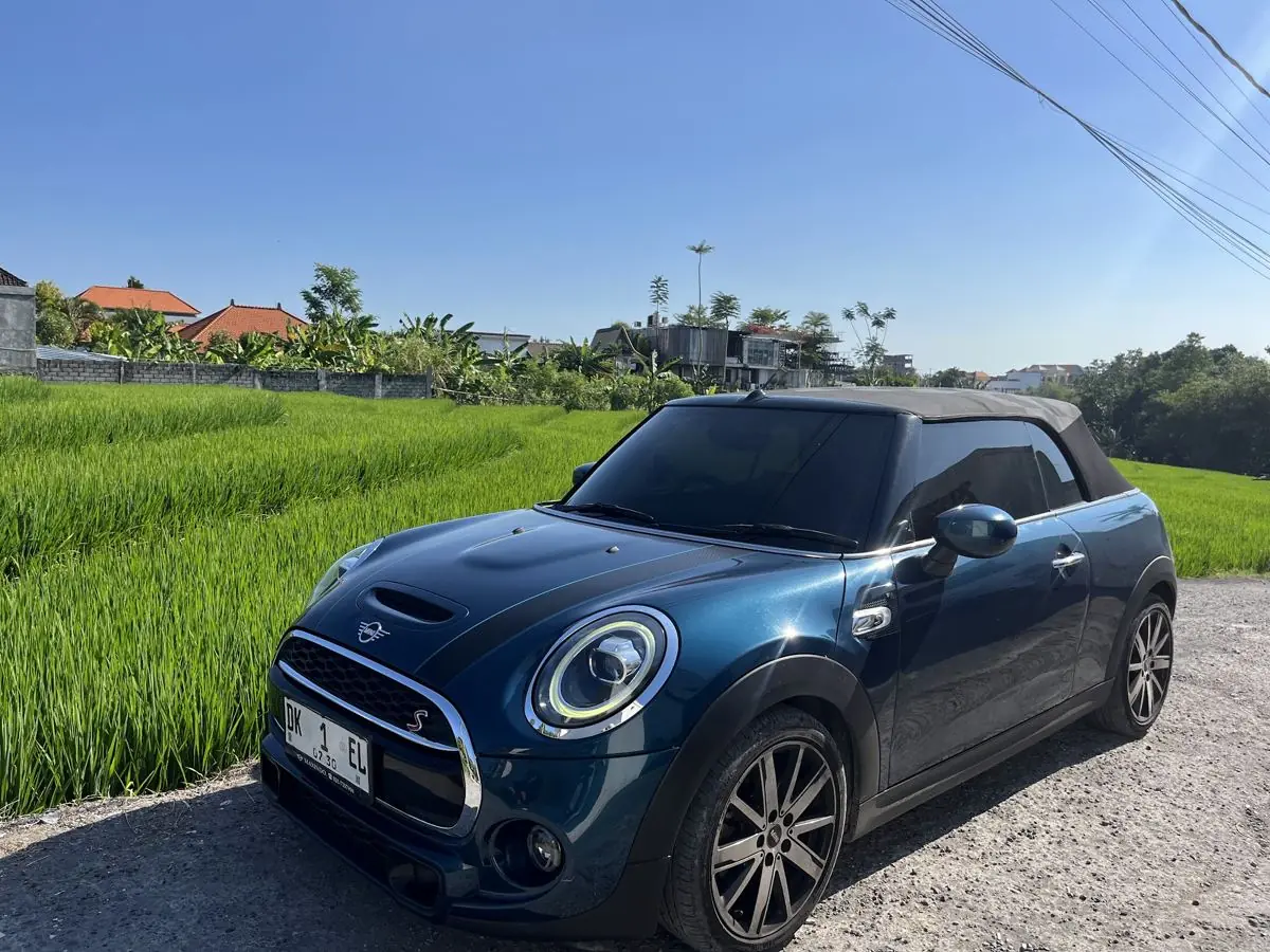 A Mini Cooper S convertible beside a rice field in Bali