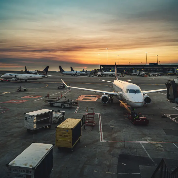 Planes at the gates of an airport terminal at sunset