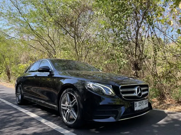 A black Mercedes-Benz E-Class saloon
