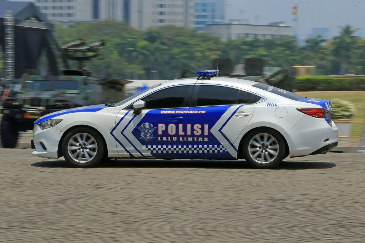 An Indonesian traffic police car on a city street