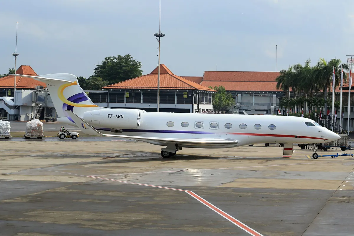 A private jet parked at a tropical airport